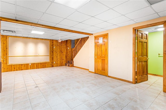 246 Johnston Rd, Bentleyville, PA 15314 - tiled empty room featuring wood walls, stairs, and a paneled ceiling
