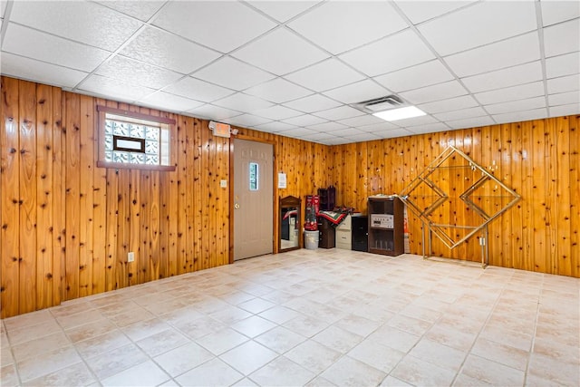 246 Johnston Rd, Bentleyville, PA 15314 - below grade area with a paneled ceiling, tile patterned floors, and wooden walls