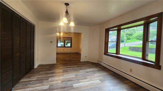 1008 Wallace St, Vandergrift Wml, PA 15690 - unfurnished dining area featuring a baseboard radiator, a chandelier, and wood finished floors