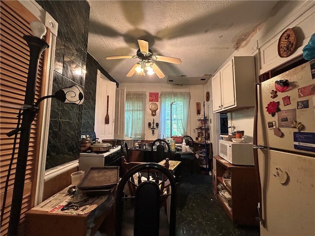 1713 Federal St, Mckeesport, PA 15132 - kitchen with white appliances, ceiling fan, white cabinetry, and a textured ceiling