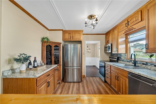 1072 Aetna Dr, Wayne Twp Law, PA 16117 - kitchen featuring stainless steel appliances, a chandelier, light wood finished floors, ornamental molding, and light countertops