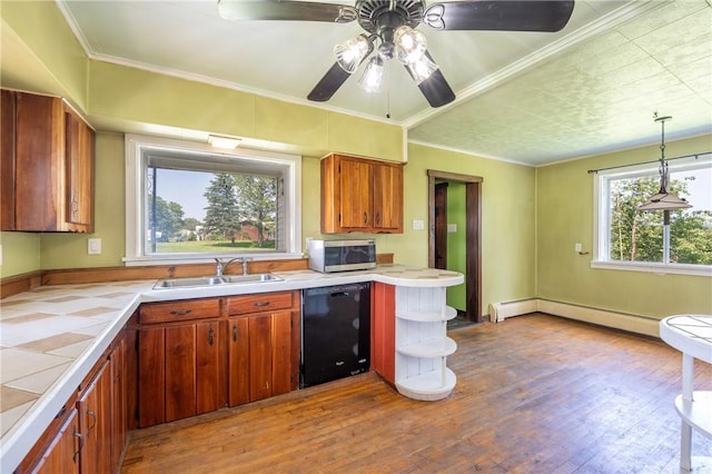 4177 Main St, Cook Twp, PA 15687 - kitchen featuring dishwasher, stainless steel microwave, tile counters, a baseboard heating unit, and wood finished floors