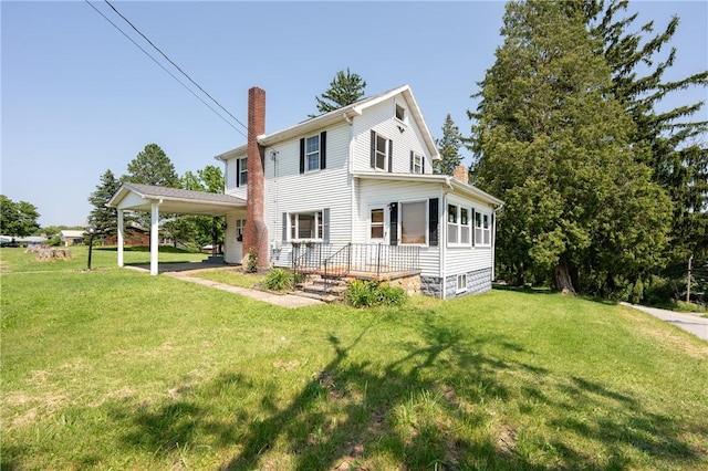 4177 Main St, Cook Twp, PA 15687 - rear view of property featuring a chimney, a lawn, and a carport