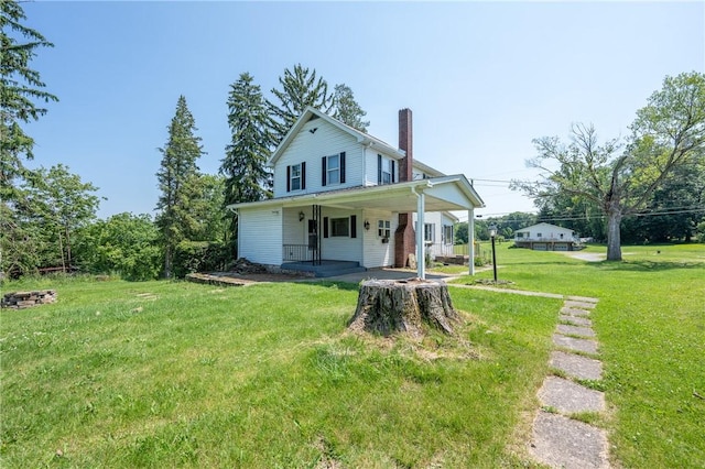 4177 Main St, Cook Twp, PA 15687 - farmhouse inspired home with covered porch, a chimney, and a front yard