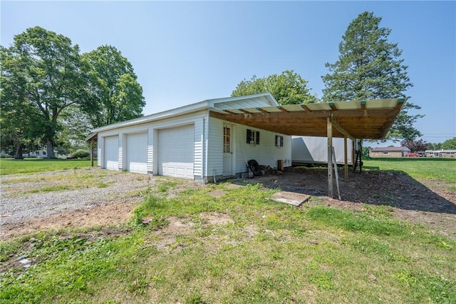 4177 Main St, Cook Twp, PA 15687 - view of property exterior featuring a garage, an outbuilding, and a lawn
