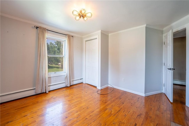 4177 Main St, Cook Twp, PA 15687 - empty room featuring hardwood / wood-style flooring, ornamental molding, and a baseboard heating unit