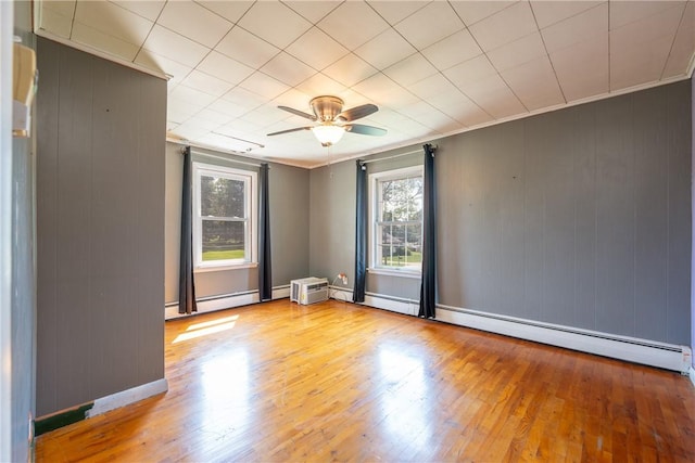 4177 Main St, Cook Twp, PA 15687 - unfurnished room featuring hardwood / wood-style floors, a ceiling fan, crown molding, a baseboard radiator, and wooden walls