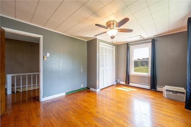 4177 Main St, Cook Twp, PA 15687 - empty room featuring ceiling fan, wood-type flooring, crown molding, and baseboard heating