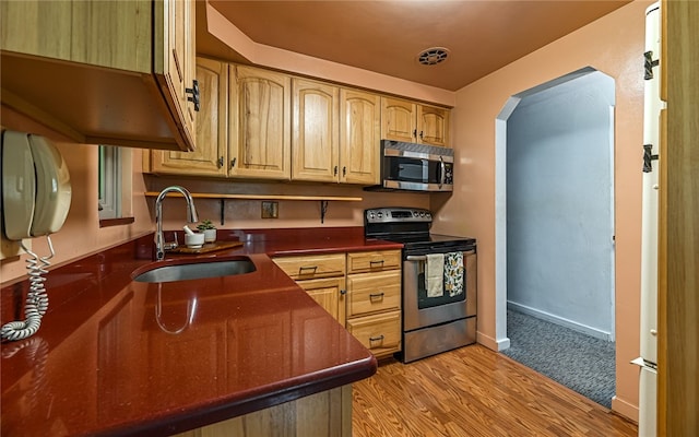 105 Hilltop Cir, Shaler, PA 15116 - kitchen featuring appliances with stainless steel finishes, dark countertops, arched walkways, and light wood finished floors