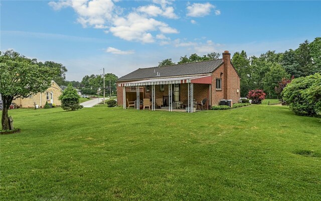 105 Hilltop Cir, Shaler, PA 15116 - back of house featuring a yard, a chimney, a patio, and brick siding