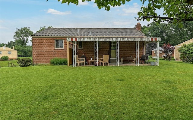105 Hilltop Cir, Shaler, PA 15116 - back of house with a chimney, a lawn, and brick siding