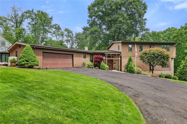 2370 Morrow Rd, Upper St Clair, PA 15241 - view of front facade featuring an attached garage, asphalt driveway, a front yard, and a chimney