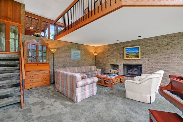 2370 Morrow Rd, Upper St Clair, PA 15241 - living room with carpet flooring, stairway, brick wall, a towering ceiling, and a fireplace