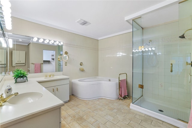 2370 Morrow Rd, Upper St Clair, PA 15241 - bathroom featuring double vanity, a shower stall, a garden tub, and tile walls