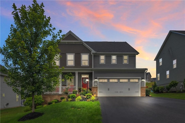 205 Regency Dr, North Strabane, PA 15330 - craftsman-style house with an attached garage, asphalt driveway, a front lawn, covered porch, and brick siding
