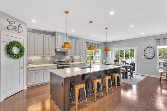 205 Regency Dr, North Strabane, PA 15330 - kitchen with electric range, a kitchen island with sink, recessed lighting, a kitchen breakfast bar, and light countertops
