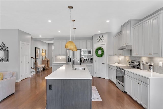 205 Regency Dr, North Strabane, PA 15330 - kitchen featuring appliances with stainless steel finishes, under cabinet range hood, tasteful backsplash, dark wood-style floors, and recessed lighting