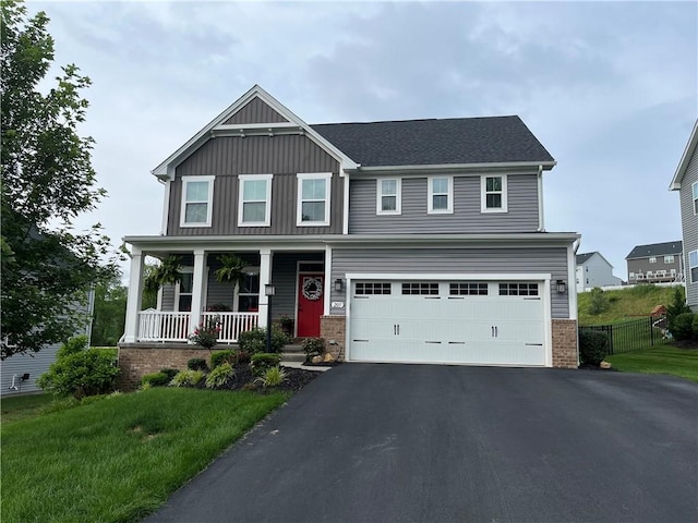 205 Regency Dr, North Strabane, PA 15330 - view of front of property with a porch, driveway, an attached garage, and board and batten siding