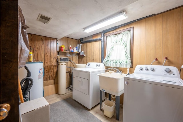 756 Arona Rd, Hempfield Twp Wml, PA 15672 - laundry area with electric water heater, independent washer and dryer, and wooden walls