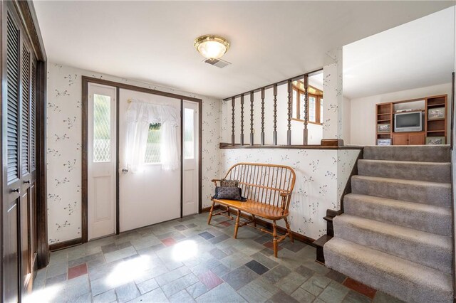 756 Arona Rd, Hempfield Twp Wml, PA 15672 - entryway featuring wallpapered walls, stairs, and stone finish flooring