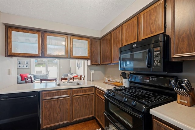 410 Redrome Cir E, South Fayette, PA 15017 - kitchen featuring black appliances, light countertops, a textured ceiling, and brown cabinetry