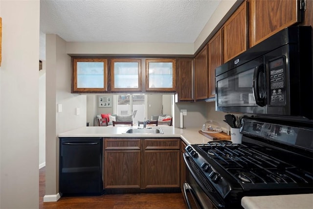 410 Redrome Cir E, South Fayette, PA 15017 - kitchen with black appliances, dark wood-style floors, light countertops, a textured ceiling, and healthy amount of natural light