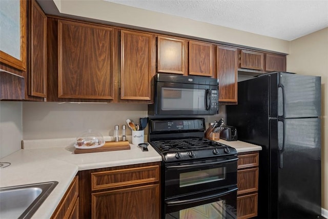 410 Redrome Cir E, South Fayette, PA 15017 - kitchen with black appliances, light countertops, and a textured ceiling