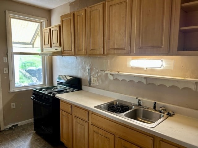 2618 Salisbury St, South Side, PA 15210 - kitchen featuring black range with gas cooktop, under cabinet range hood, open shelves, light countertops, and backsplash