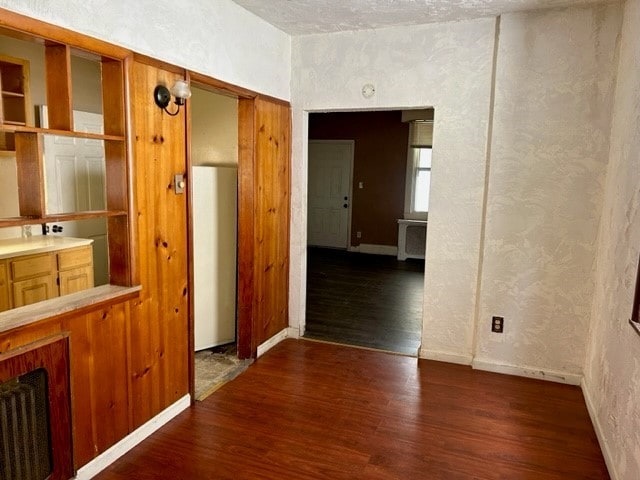 2618 Salisbury St, South Side, PA 15210 - empty room with wood finished floors and a textured wall