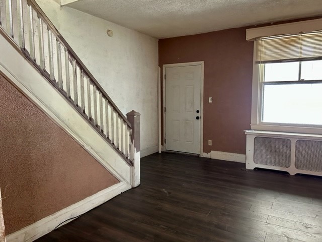 2618 Salisbury St, South Side, PA 15210 - foyer featuring radiator, wood finished floors, stairway, and a textured ceiling