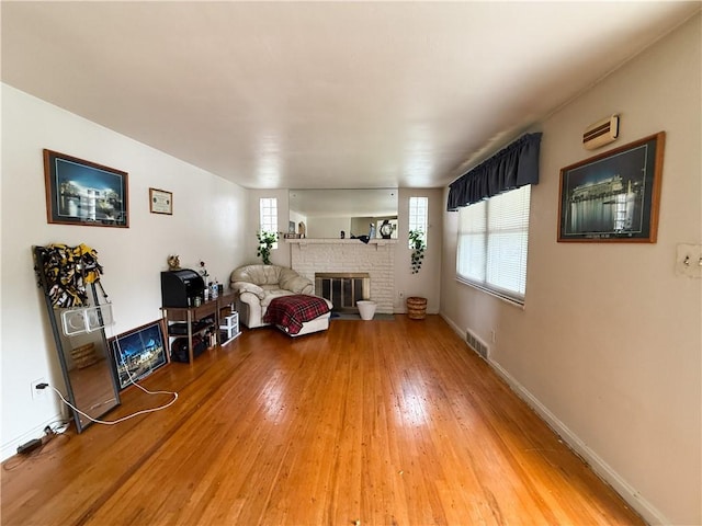 1320 Main St, Bridgeville, PA 15017 - living area featuring a fireplace, light wood-style floors, and plenty of natural light