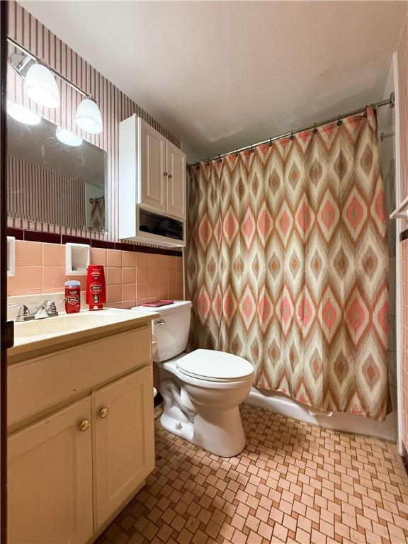 1320 Main St, Bridgeville, PA 15017 - full bath with vanity, tile walls, and a shower with shower curtain
