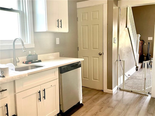 424 Hess Ave, Erie City, PA 16507 - kitchen with stainless steel dishwasher, light wood-style flooring, white cabinetry, and light countertops