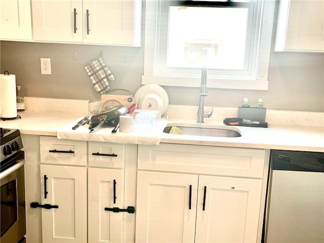 424 Hess Ave, Erie City, PA 16507 - kitchen with dishwashing machine, white cabinets, light countertops, and stainless steel stove