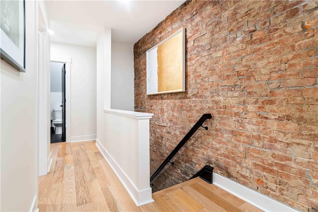 161 Morewood, Oakland, PA 15213 - corridor with an upstairs landing, wood finished floors, and brick wall