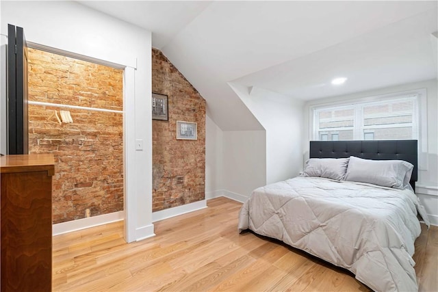 161 Morewood, Oakland, PA 15213 - bedroom featuring light wood-type flooring, lofted ceiling, and brick wall