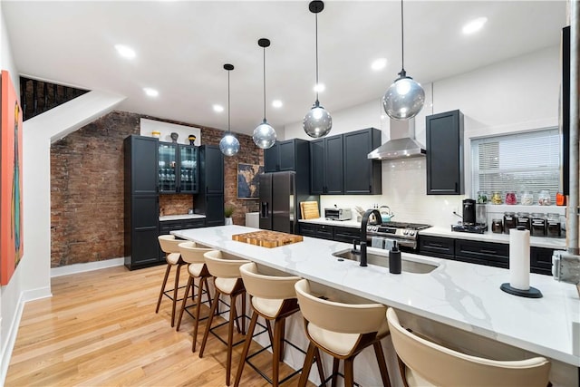 161 Morewood, Oakland, PA 15213 - kitchen featuring refrigerator with ice dispenser, a kitchen bar, dark cabinetry, pendant lighting, and recessed lighting