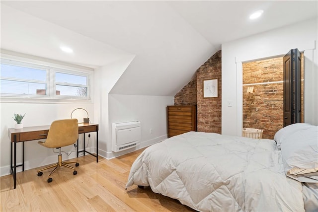 161 Morewood, Oakland, PA 15213 - bedroom featuring vaulted ceiling, wood finished floors, heating unit, brick wall, and a desk