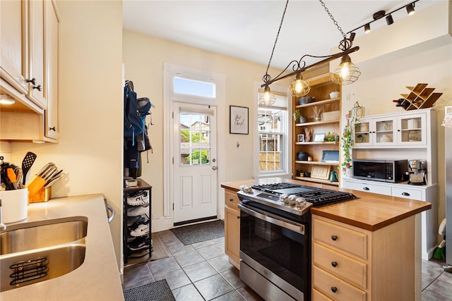 625 S Aiken Ave, Shadyside, PA 15232 - kitchen featuring appliances with stainless steel finishes, butcher block counters, open shelves, pendant lighting, and glass insert cabinets