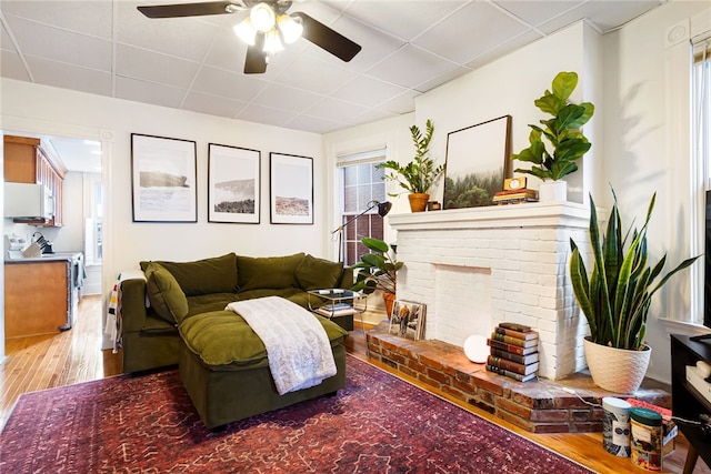 625 S Aiken Ave, Shadyside, PA 15232 - living area with wood finished floors, ceiling fan, a drop ceiling, and a fireplace