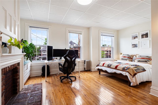 625 S Aiken Ave, Shadyside, PA 15232 - bedroom with a paneled ceiling, hardwood / wood-style floors, an office area, radiator, and a fireplace
