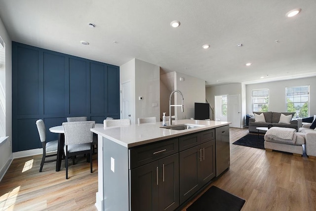 1408 Commons Ln, South Fayette, PA 15017 - kitchen featuring stainless steel dishwasher, a decorative wall, healthy amount of natural light, light wood-style floors, and light countertops