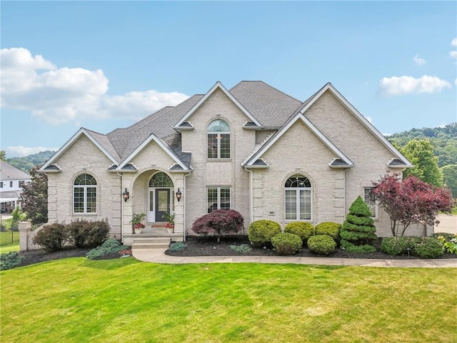 203 Cashmere Ct, Cranberry Twp, PA 16066 - view of front of house featuring a front yard, a shingled roof, and brick siding