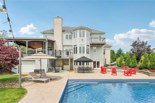 203 Cashmere Ct, Cranberry Twp, PA 16066 - back of house featuring a balcony, a chimney, stairway, a patio, and an outdoor pool