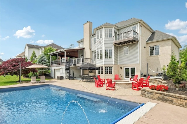 203 Cashmere Ct, Cranberry Twp, PA 16066 - rear view of house featuring a balcony, a patio area, stairs, a chimney, and an outdoor pool