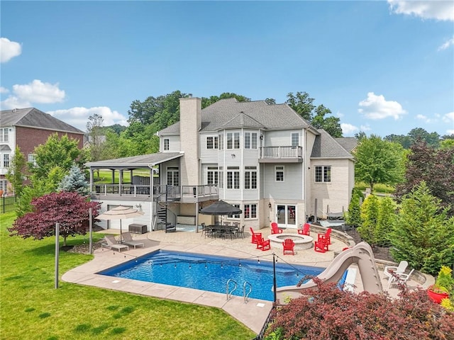 203 Cashmere Ct, Cranberry Twp, PA 16066 - back of property featuring a balcony, a chimney, a lawn, a patio area, and an outdoor pool