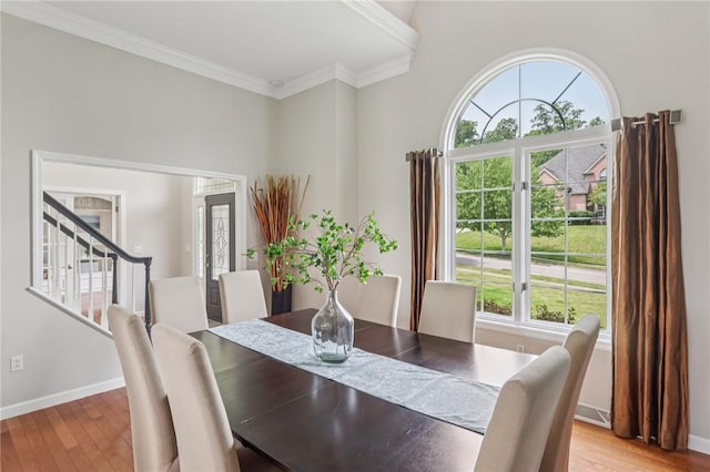203 Cashmere Ct, Cranberry Twp, PA 16066 - dining room featuring light wood finished floors, stairway, and crown molding