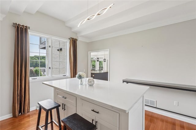 203 Cashmere Ct, Cranberry Twp, PA 16066 - kitchen featuring light wood-style floors, white cabinetry, light countertops, a kitchen island, and crown molding