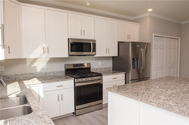132 Hidden Acres Dr, Forward Twp, PA 16033 - kitchen featuring appliances with stainless steel finishes, white cabinets, ornamental molding, light wood finished floors, and light stone counters