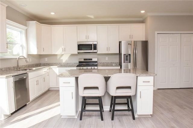 132 Hidden Acres Dr, Forward Twp, PA 16033 - kitchen featuring appliances with stainless steel finishes, a center island, ornamental molding, white cabinets, and recessed lighting